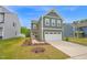 Charming two-story home with a two-car garage and a welcoming pink front door at 1501 Addison Lake St, Fuquay Varina, NC 27526