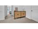 Hallway showing cabinet in neutral tones, lamp, and doorway to a bedroom at 1501 Addison Lake St, Fuquay Varina, NC 27526