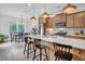 Modern kitchen with a quartz countertop island, stainless steel appliances and stylish pendant lights at 1501 Addison Lake St, Fuquay Varina, NC 27526