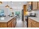 Well-equipped kitchen with stainless steel appliances, island and breakfast bar with backyard view at 1501 Addison Lake St, Fuquay Varina, NC 27526