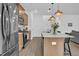 Open kitchen featuring stainless steel appliances, a spacious island, and modern pendant lighting at 1501 Addison Lake St, Fuquay Varina, NC 27526