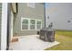 Concrete patio featuring a grill, exterior door, and three windows providing natural light at 1501 Addison Lake St, Fuquay Varina, NC 27526