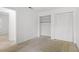 Bedroom featuring neutral carpeting, a closet, and a large window for ample natural light at 158 Poplar St # A, Chapel Hill, NC 27516