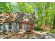 Home exterior showcasing a gray facade, orange front door with a wooden walkway, deck, and surrounded by lush landscaping at 158 Poplar St # A, Chapel Hill, NC 27516