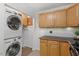 Kitchen featuring appliances, adjacent washer/dryer, and wooden cabinets at 158 Poplar St # A, Chapel Hill, NC 27516