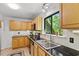 Kitchen with wooden cabinets, stainless steel appliances, and black countertops at 158 Poplar St # A, Chapel Hill, NC 27516