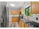 Kitchen with stainless steel sink and appliances, and light wood cabinets at 158 Poplar St # A, Chapel Hill, NC 27516