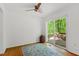 Bright living room with wood floors, a ceiling fan, and a sliding glass door offering access to an outdoor deck at 158 Poplar St # A, Chapel Hill, NC 27516