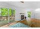 Bright living room featuring a fireplace, hardwood floors, and sliding glass doors to a deck at 158 Poplar St # A, Chapel Hill, NC 27516