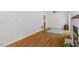 Living room featuring hardwood floors, access to the dining area, a ceiling fan, and a fireplace with stone surround at 158 Poplar St # A, Chapel Hill, NC 27516