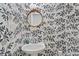 Charming powder room featuring wallpaper with a floral design and a round decorative mirror at 158 Poplar St # A, Chapel Hill, NC 27516