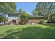 Large backyard with a patio, lush lawn, and mature trees at 1636 Cone Ave, Apex, NC 27502