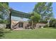 Exterior view of a brick home with a large backyard and patio at 1636 Cone Ave, Apex, NC 27502