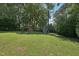 Spacious backyard with large lawn, storage shed, and a play structure at 1636 Cone Ave, Apex, NC 27502