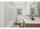 Bright bathroom with subway tiles in the shower and a modern vanity with matte black hardware at 1636 Cone Ave, Apex, NC 27502