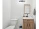 Modern bathroom featuring a wood vanity, sleek sink, and minimalist design for a clean and stylish look at 1636 Cone Ave, Apex, NC 27502