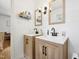 Bathroom featuring double sinks with modern fixtures and a stylish wooden cabinet at 1636 Cone Ave, Apex, NC 27502