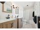 A bright bathroom with a double sink vanity, a shower, and marble tile floors at 1636 Cone Ave, Apex, NC 27502