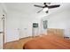 A bright bedroom with a dresser, and a view of the outdoors through the window at 1636 Cone Ave, Apex, NC 27502