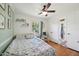Bright bedroom features a ceiling fan and a window with a view of the outdoors at 1636 Cone Ave, Apex, NC 27502