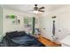 Well-decorated bedroom with hardwood floors, a ceiling fan, and a playful dinosaur-themed corner at 1636 Cone Ave, Apex, NC 27502