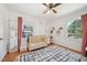 Cozy Bedroom with a wooden crib, a dresser, and a stylish black and white rug at 1636 Cone Ave, Apex, NC 27502