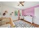 A sweet Bedroom featuring a crib, rocking chair, and dresser with charming decor at 1636 Cone Ave, Apex, NC 27502