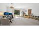 Bonus room with a desk, sofa, and access to the backyard at 1636 Cone Ave, Apex, NC 27502