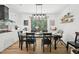Open dining area with wood floors, a modern light fixture, and a view into the kitchen, creating an inviting atmosphere at 1636 Cone Ave, Apex, NC 27502