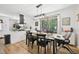 Dining room seamlessly connects to the kitchen, featuring modern lighting, wood floors, and a bright, open space at 1636 Cone Ave, Apex, NC 27502