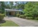 View of a brick home with an attached carport and long concrete driveway at 1636 Cone Ave, Apex, NC 27502