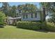 Charming two-story home featuring a brick and siding exterior, lush landscaping, and a well-maintained lawn at 1636 Cone Ave, Apex, NC 27502