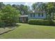 View of a charming home with lush landscaping, mature trees and healthy green lawn at 1636 Cone Ave, Apex, NC 27502