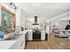 Open kitchen with white countertops, stainless steel appliances, and an inviting view into the living and dining areas at 1636 Cone Ave, Apex, NC 27502