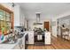 Well-lit kitchen with white cabinets, hardwood floors, and modern black appliances at 1636 Cone Ave, Apex, NC 27502
