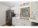 Kitchen with white cabinets, subway tile backsplash, stainless steel appliances, and wood-look floors for a modern touch at 1636 Cone Ave, Apex, NC 27502