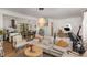 Open-concept living space flowing into dining area, with hardwood floors and natural light at 1636 Cone Ave, Apex, NC 27502