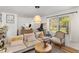 Bright living room featuring hardwood floors, neutral decor, and comfortable seating at 1636 Cone Ave, Apex, NC 27502