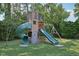 Backyard wooden playset features slides, a swing set, and ample room for outdoor fun at 1636 Cone Ave, Apex, NC 27502