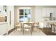 Bright dining area features a round table with seating for six, modern lighting, and neutral tones at 1645 Goldfinch Perch Ln, Knightdale, NC 27545