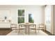 Inviting dining area features a round table with seating for six and lots of natural light at 1645 Goldfinch Perch Ln, Knightdale, NC 27545