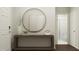 Inviting entryway with console table, decorative mirror, and access to a well-lit bathroom at 1645 Goldfinch Perch Ln, Knightdale, NC 27545