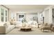 Open-concept living room with white sofa, natural wood accents, and a view to the kitchen at 1645 Goldfinch Perch Ln, Knightdale, NC 27545