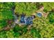 Aerial view of home and grounds with mature trees. Located close to the UNC Chapel Hill at 1715 Us 15-501 S, Chapel Hill, NC 27517