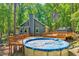 View of the backyard of this home which features a spacious wooden deck and a pool at 1715 Us 15-501 S, Chapel Hill, NC 27517