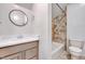 Bathroom featuring vanity with drawers, round mirror, toilet, and tiled shower/tub combo at 1715 Us 15-501 S, Chapel Hill, NC 27517