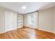 Bright bedroom features beautiful hardwood floors, built-in shelving, and a window with natural light at 1715 Us 15-501 S, Chapel Hill, NC 27517