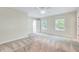 Spacious bedroom features neutral carpet, a ceiling fan, and sun-filled windows at 1715 Us 15-501 S, Chapel Hill, NC 27517