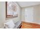 Welcoming entryway featuring a wood floor, bench seating, and a stylish decorative painting at 1715 Us 15-501 S, Chapel Hill, NC 27517