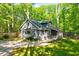 Charming home with gray siding, white trim, inviting front porch, and mature trees at 1715 Us 15-501 S, Chapel Hill, NC 27517